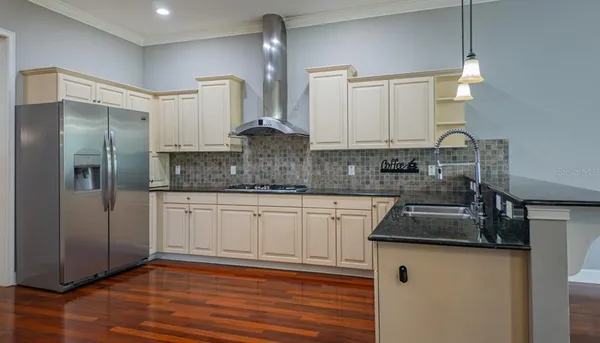 a kitchen with granite countertop white cabinets and sink