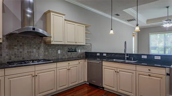 a kitchen with stainless steel appliances a sink and a refrigerator