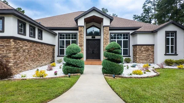 a front view of a house with garden
