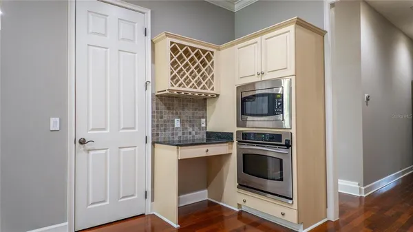 an empty room with windows and closet area