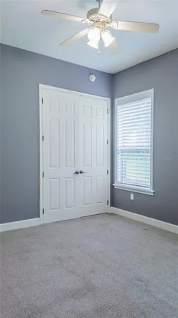 a view of cabinets and utility room with racks on the wall