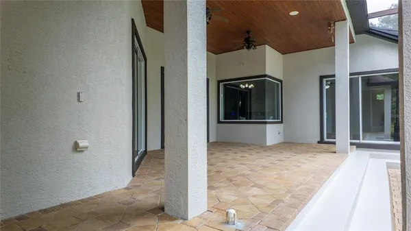 a backyard of a house with table and chairs
