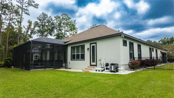 an aerial view of a house with pool patio and outdoor seating