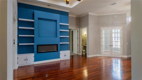a living room with hard wood floors and a fireplace