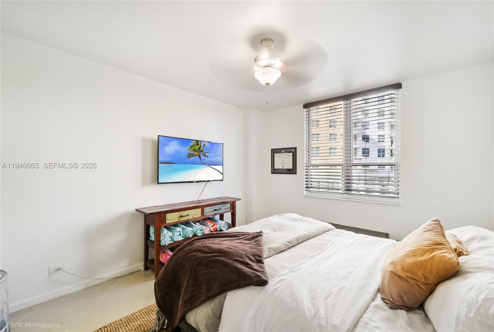 701 Brickell Key Boulevard, Unit 404 Miami, FL 33131 - Photo 9 of 12 a bedroom with a bed and a painting on the wall