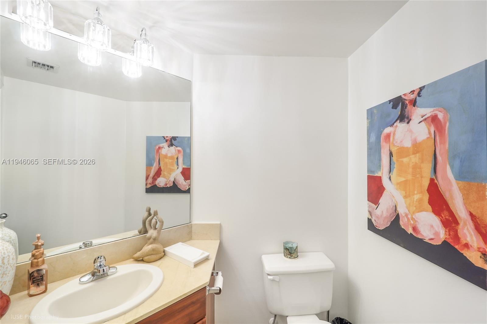 701 Brickell Key Boulevard, Unit 404 Miami, FL 33131 - Photo 10 of 12 a bathroom with a sink mirror and toilet