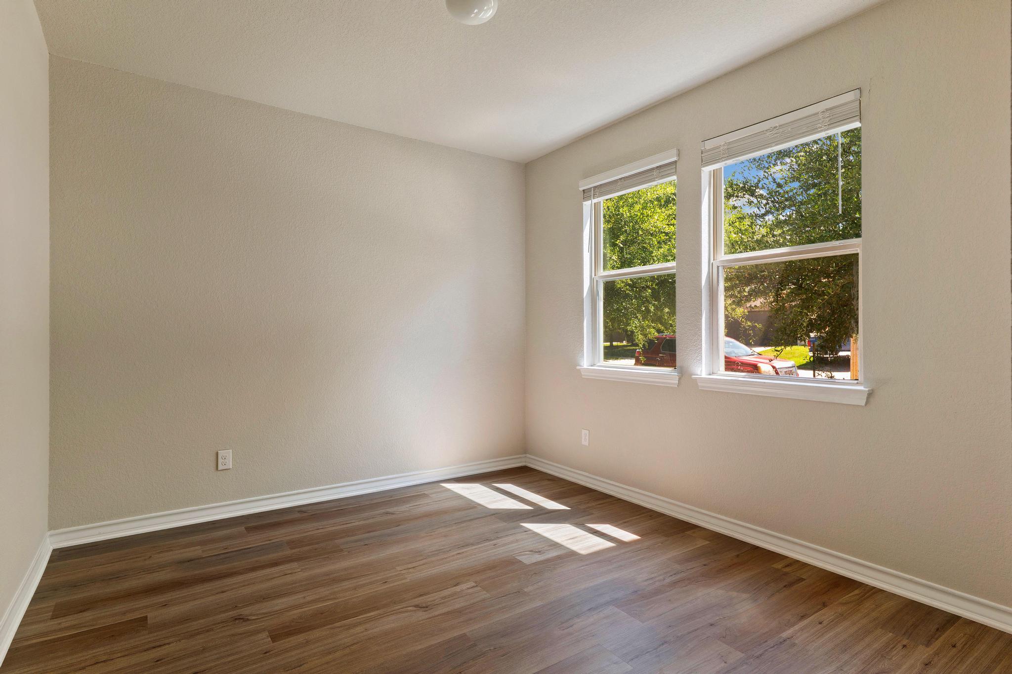 1341 Eagle Ray Street Leander, TX 78641 - Photo 13 of 37 Sun-filled room with wood flooring offers tranquil views through its windows.