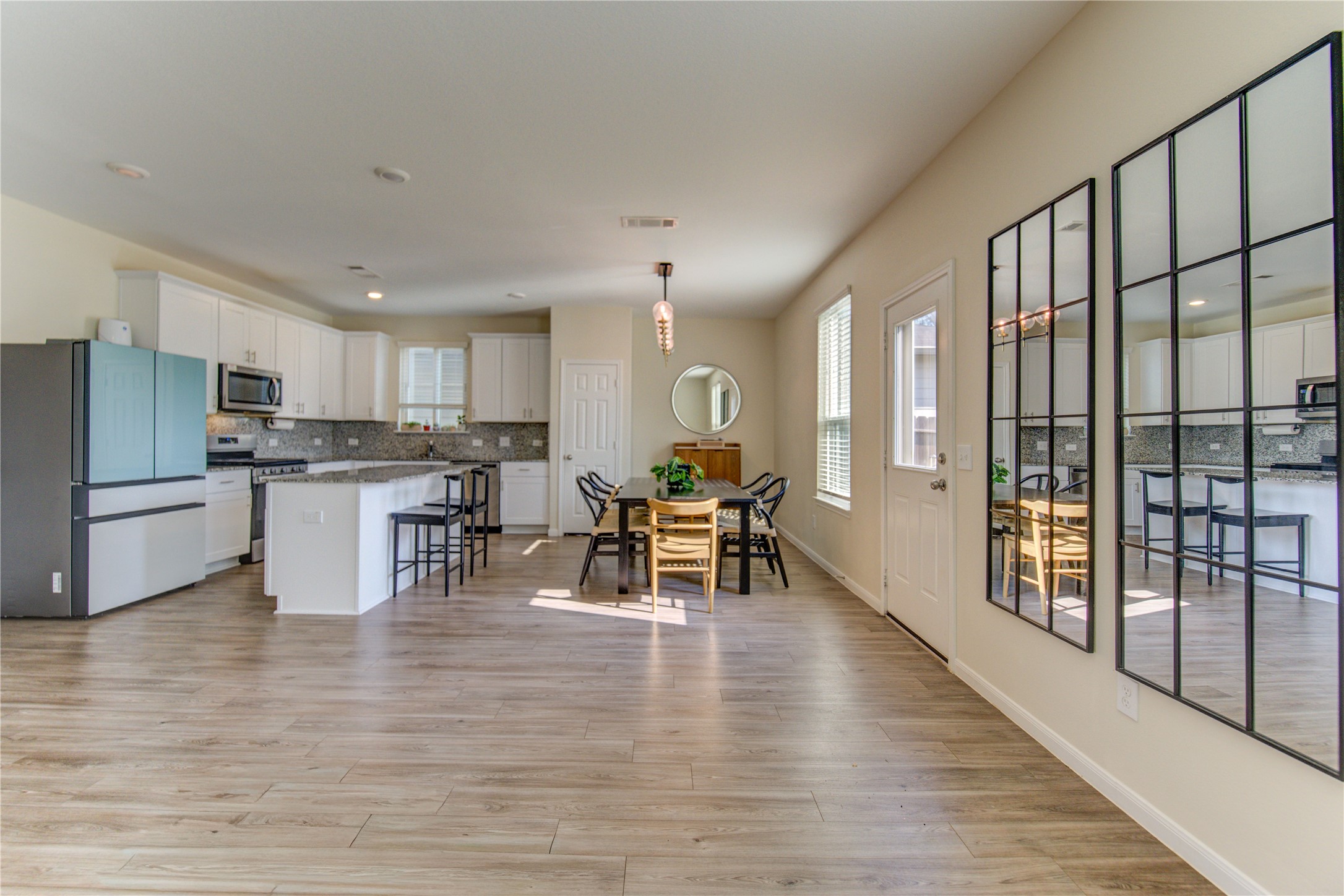 6706 Hobby Wind Ridge Drive Houston, TX 77075 - Photo 17 of 31 a kitchen with stainless steel appliances granite countertop a stove top oven a sink a dining table and chairs