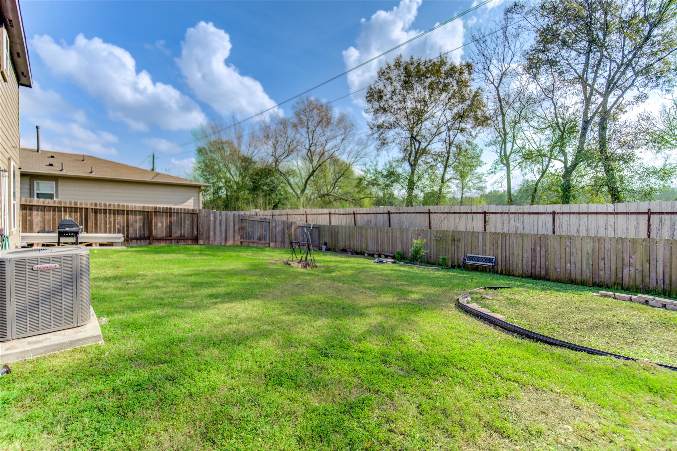 6706 Hobby Wind Ridge Drive Houston, TX 77075 - Photo 25 of 31 a view of a yard with a large tree and wooden fence