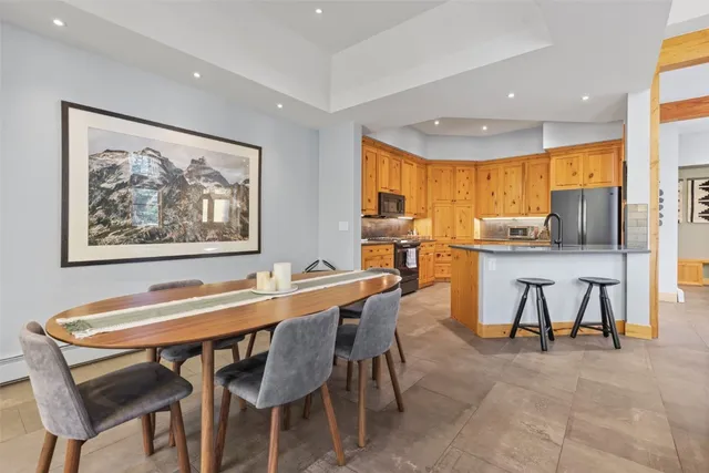 a view of a dining room with furniture and a floor to ceiling window