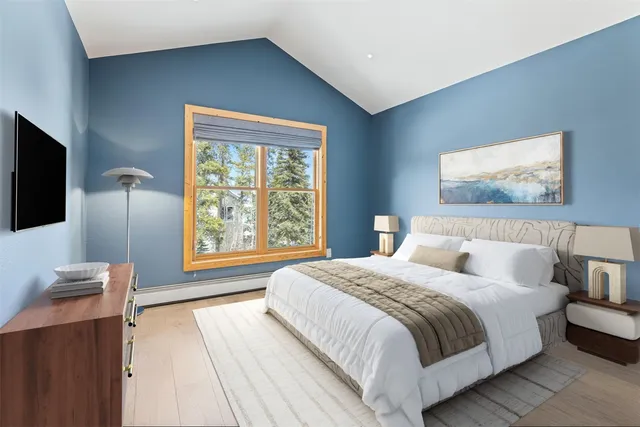 a bedroom with a bed and a flat screen tv