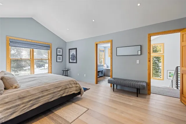 a bedroom with a bed and a large window