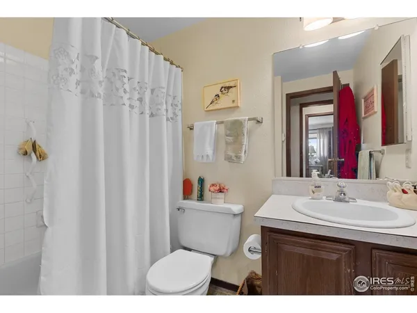 a bathroom with a sink mirror vanity and toilet