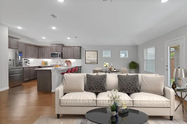 a living room with furniture and kitchen view