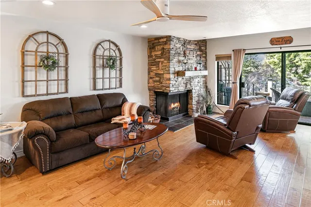 a living room with furniture fireplace and a large window