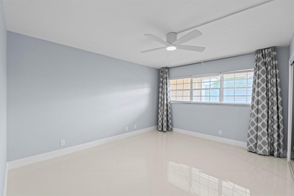 3090 North Course Drive, Unit 309 Pompano Beach, FL 33069 - Photo 11 of 21 a view of an empty room with a window
