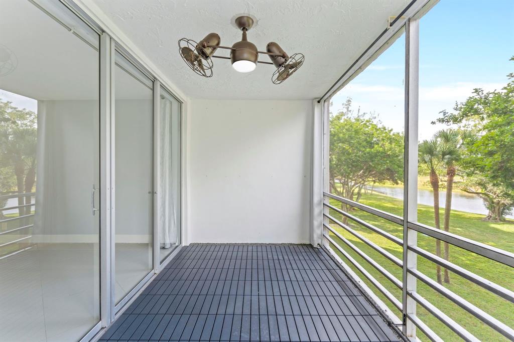 3090 North Course Drive, Unit 309 Pompano Beach, FL 33069 - Photo 18 of 21 a view of a room with wooden floor and windows