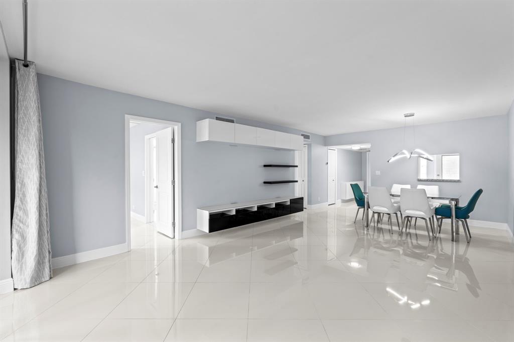 3090 North Course Drive, Unit 309 Pompano Beach, FL 33069 - Photo 4 of 21 a view of a dining room with furniture and a window