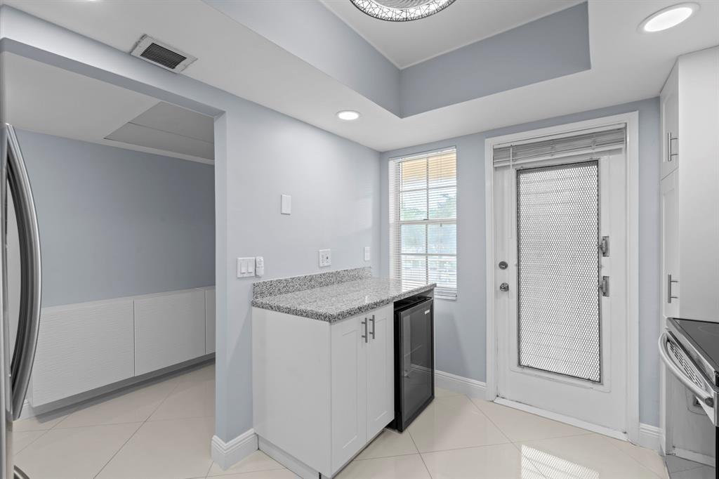 3090 North Course Drive, Unit 309 Pompano Beach, FL 33069 - Photo 9 of 21 a utility room with cabinets washer and dryer