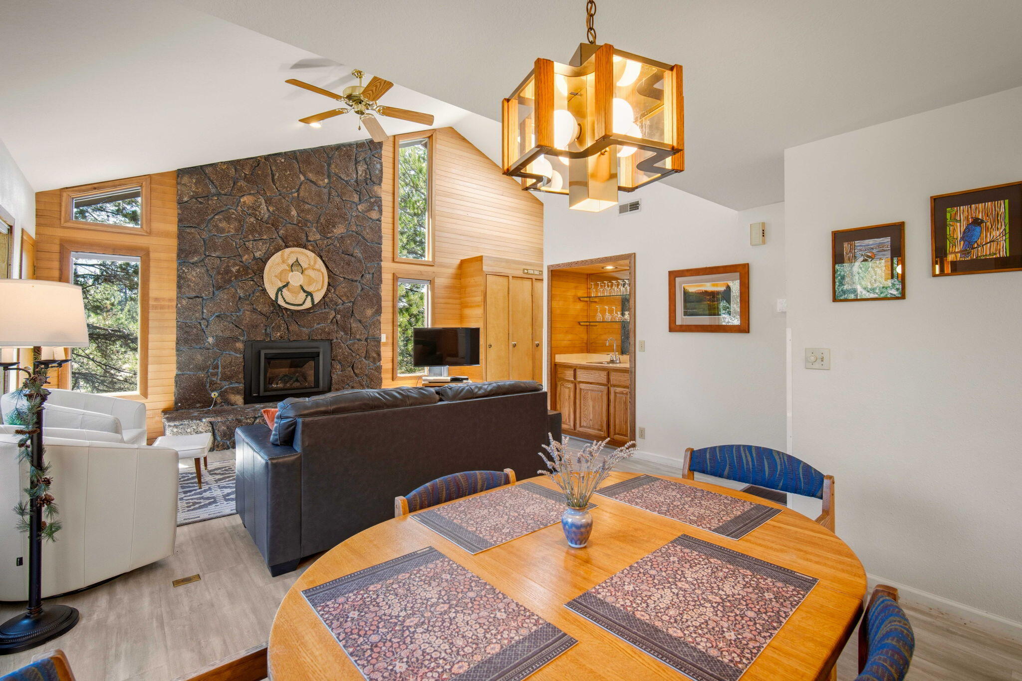 57305 Beaver Ridge Loop, Unit 8 Sunriver, OR 97707 - Photo 7 of 25 a living room with furniture a rug a fireplace and a chandelier