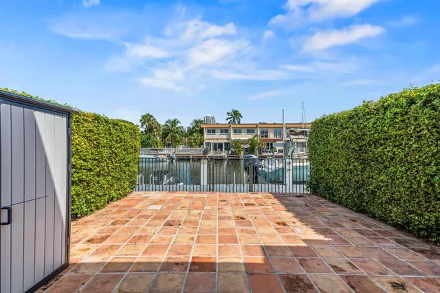 a aerial view of a house with swimming pool lawn chairs and a yard