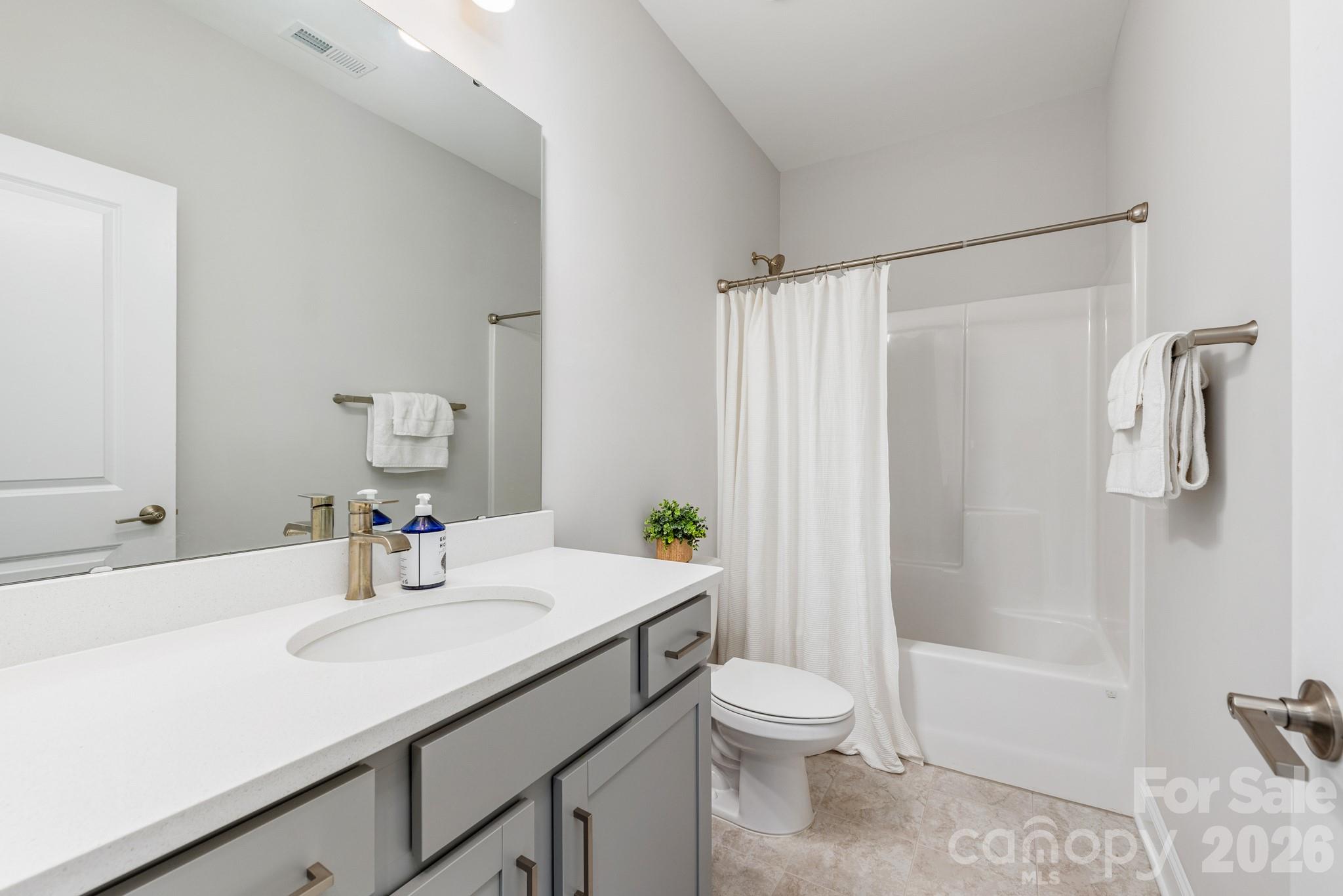 17210 Sand Bank Road Charlotte, NC 28278 - Photo 14 of 20 a bathroom with a sink a toilet and shower
