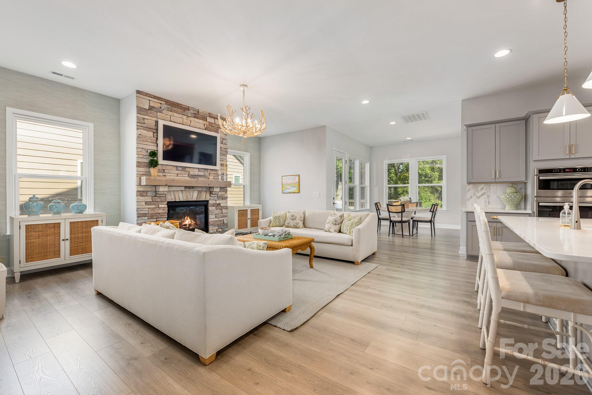 17210 Sand Bank Road Charlotte, NC 28278 - Photo 5 of 20 a living room with furniture a fireplace and a flat screen tv