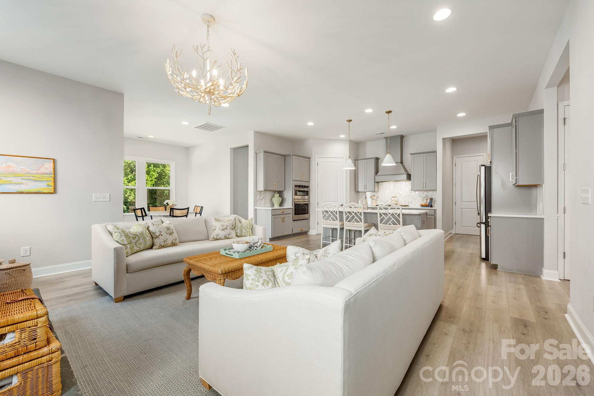 17210 Sand Bank Road Charlotte, NC 28278 - Photo 6 of 20 a living room with furniture and a chandelier