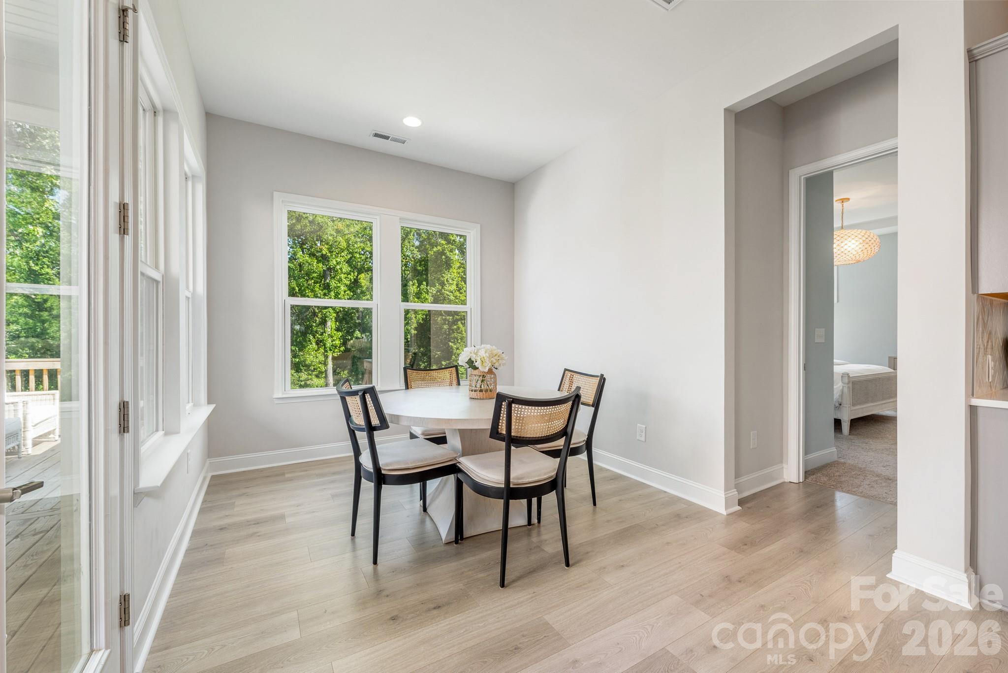 17210 Sand Bank Road Charlotte, NC 28278 - Photo 7 of 20 a dining room with furniture and wooden floor