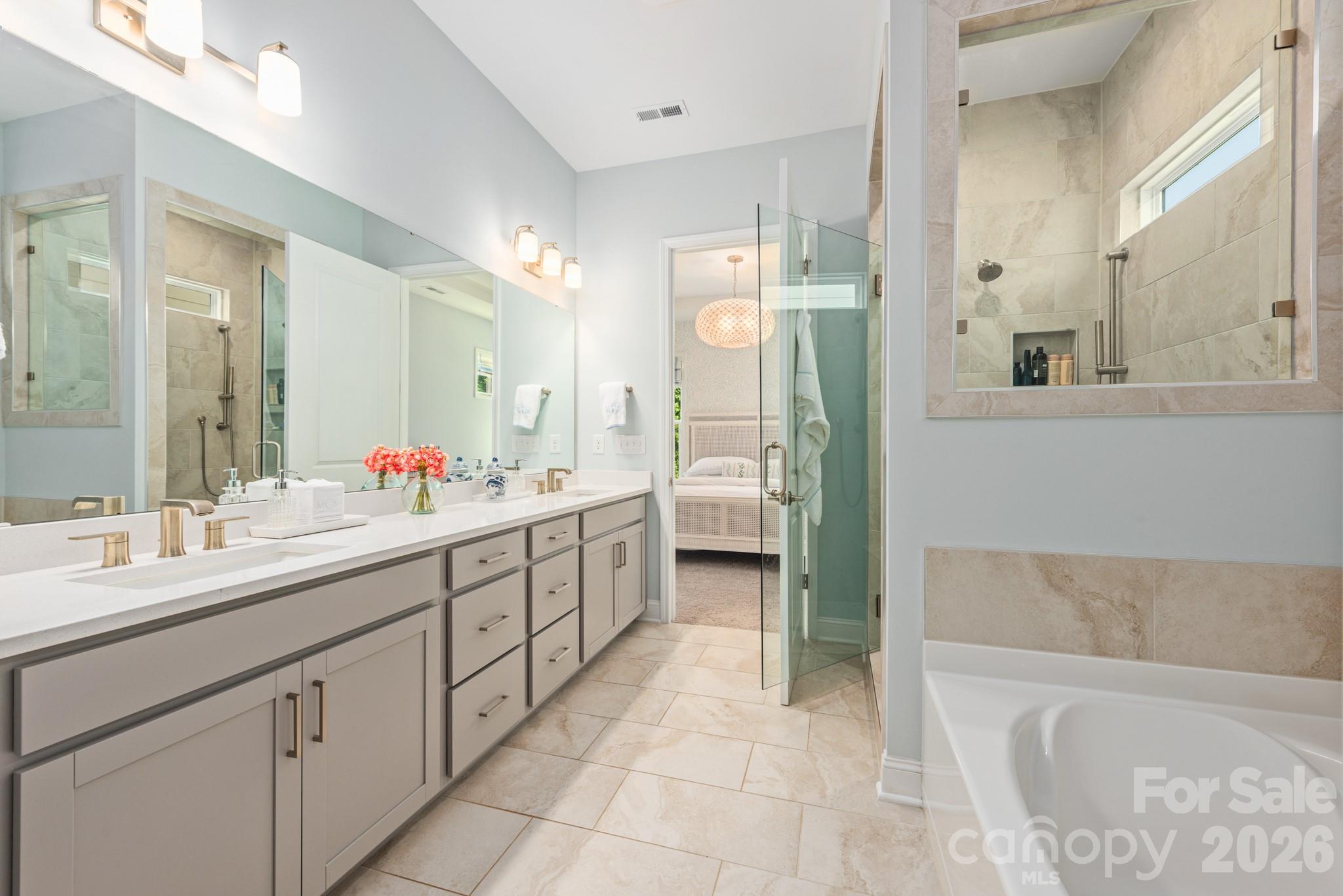 17210 Sand Bank Road Charlotte, NC 28278 - Photo 9 of 20 a spacious bathroom with a tub sink shower and mirror