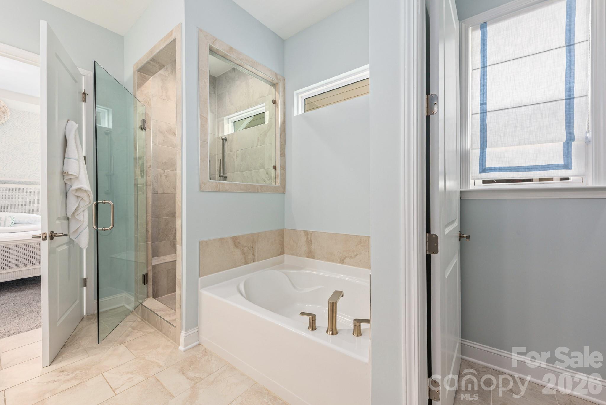 17210 Sand Bank Road Charlotte, NC 28278 - Photo 10 of 20 a white bath tub sitting next to a shower
