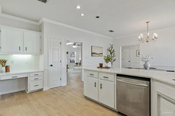 a kitchen with stainless steel appliances and white cabinets
