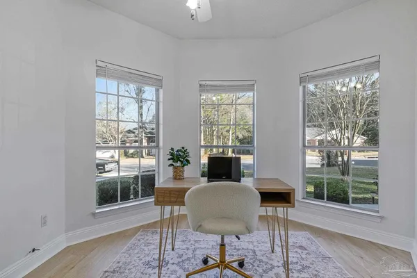 a view of a dining room with furniture window and wooden floor