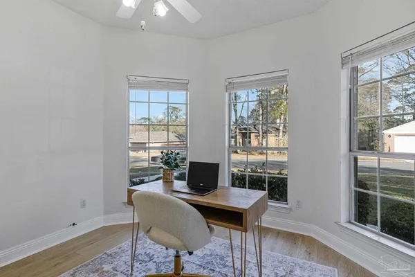 a spacious bedroom with a bed a chandelier and a window