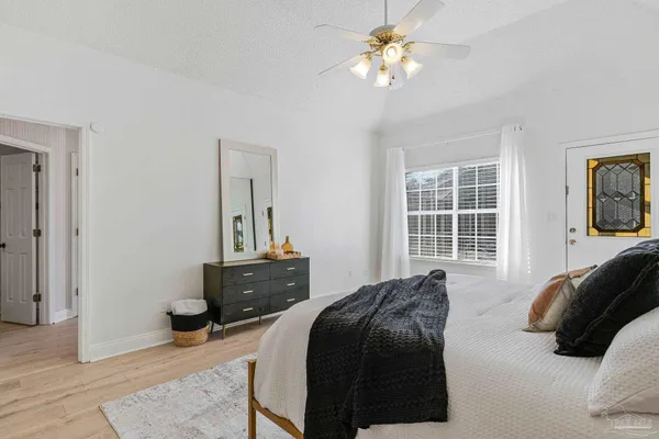 a living room with furniture ceiling fan and a rug