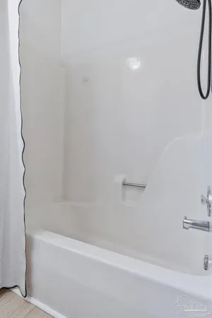 a view of a small house with wooden fence