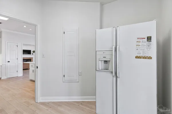 a backyard of a house with table and chairs and a large tree