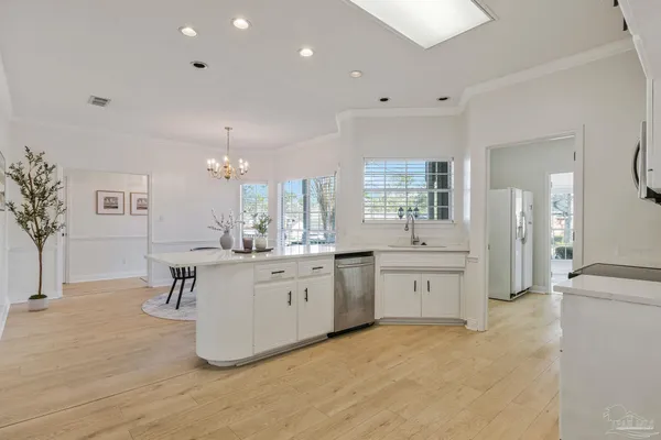 a view of a dining room with furniture and chandelier