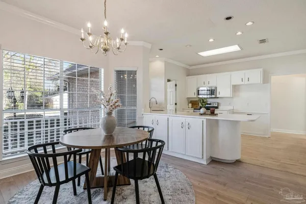 a view of a dining room with furniture and chandelier