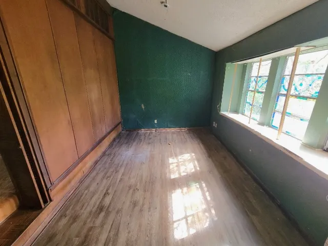 a view of a room with wooden floor and windows