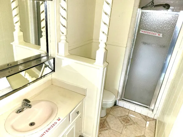 a bathroom with a sink a toilet and a mirror