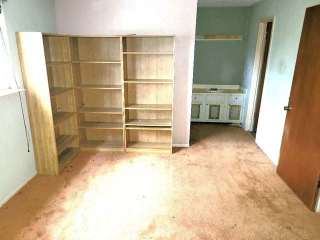 a view of walk in closet with empty racks