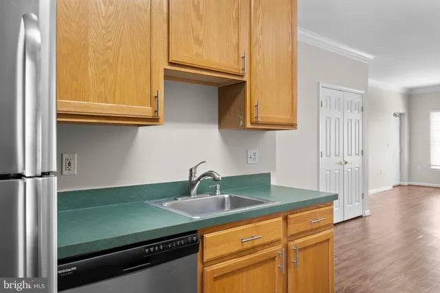 a kitchen with stainless steel appliances granite countertop a sink and a cabinets