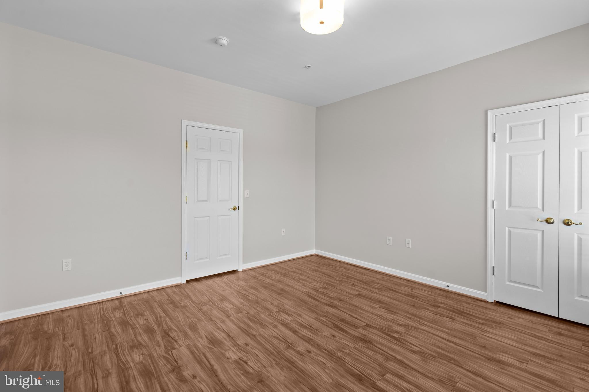 402 Main Street, Unit 300 Gaithersburg, MD 20878 - Photo 15 of 30 a view of an empty room with wooden floor
