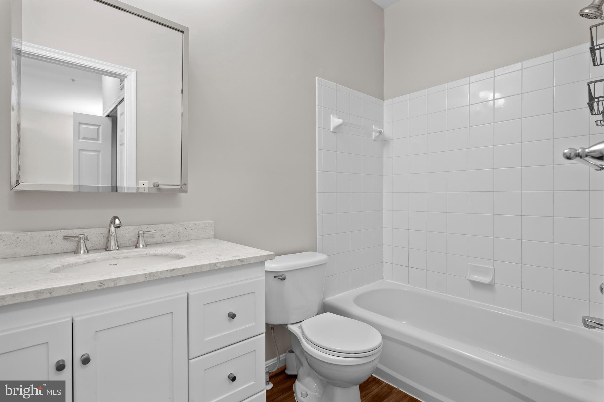 402 Main Street, Unit 300 Gaithersburg, MD 20878 - Photo 16 of 30 a bathroom with a sink a toilet and a bathtub