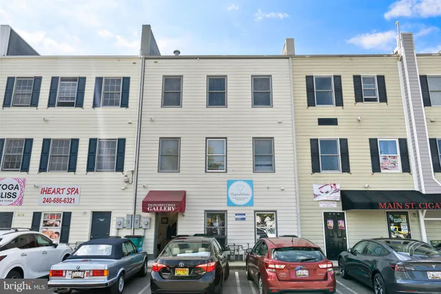 a front view of a building with parking space