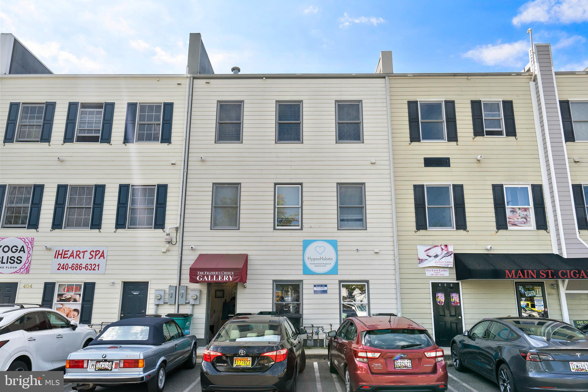 402 Main Street, Unit 300 Gaithersburg, MD 20878 - Photo 18 of 30 a front view of a building with parking space