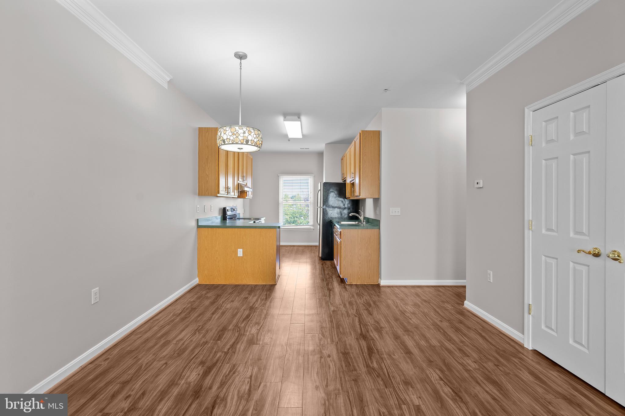 402 Main Street, Unit 300 Gaithersburg, MD 20878 - Photo 5 of 30 a view of a kitchen with wooden floor and a window