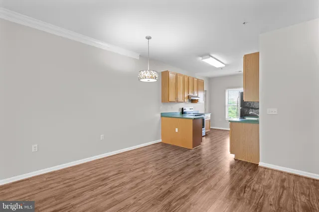 a view of a kitchen with wooden floor and a sink