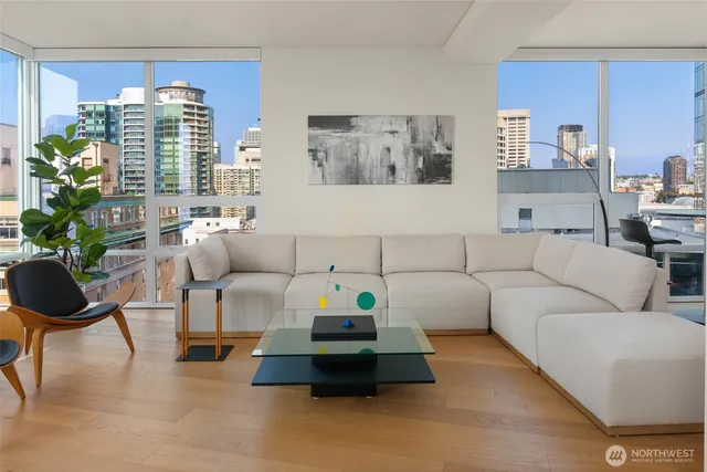 a living room with furniture and a potted plant